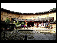 Photo shows the Tianluokeng Tulou, earth buildings in Chinese, in Nanjing County, southeast China's Fujian Province. Built on a base of stone, the thick walls of Tulou were packed with dirt and fortified with wood or bamboo internally. The architectural arts of the Fujian Tulou can be traced back nearly 1,000 years, and their design incorporates the tradition of fengshui (favorable siting within the environment). [老人河  /forums.nphoto.net]