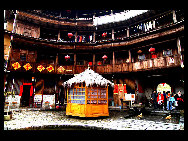 Photo shows the Tianluokeng Tulou, earth buildings in Chinese, in Nanjing County, southeast China's Fujian Province. Built on a base of stone, the thick walls of Tulou were packed with dirt and fortified with wood or bamboo internally. The architectural arts of the Fujian Tulou can be traced back nearly 1,000 years, and their design incorporates the tradition of fengshui (favorable siting within the environment). [老人河  /forums.nphoto.net]