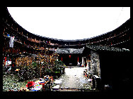 Photo shows the Tianluokeng Tulou, earth buildings in Chinese, in Nanjing County, southeast China's Fujian Province. Built on a base of stone, the thick walls of Tulou were packed with dirt and fortified with wood or bamboo internally. The architectural arts of the Fujian Tulou can be traced back nearly 1,000 years, and their design incorporates the tradition of fengshui (favorable siting within the environment). [老人河  /forums.nphoto.net]