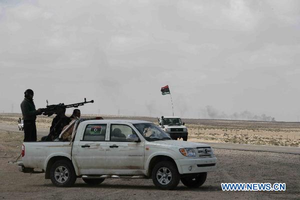 Rebels guard the front line on the road between Ajdabiyah and Brega as forces loyal to Muammar Gaddafi threatened to push them further away from strategic oil refineries in eastern Libya March 31, 2011. Rebels massed outside Brega on Thursday said their forces were still fighting Muammar Gaddafi's troops for control of the east Libya oil town. [Nasser Nouri/Xinhua] 