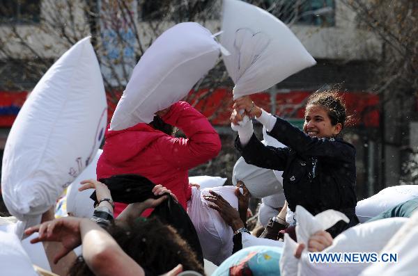 People participate in a pillow fight at the Union Square in New York, the United States, April 2, 2011. Crowds of revelers equipped with soft pillows enjoyed Saturday a massive pillow fight during the International Pillow Fighting Day here in New York.