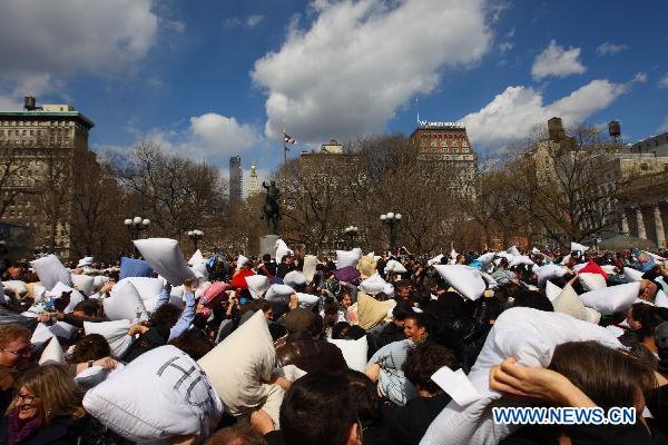 People participate in a pillow fight at the Union Square in New York, the United States, April 2, 2011. Crowds of revelers equipped with soft pillows enjoyed Saturday a massive pillow fight during the International Pillow Fighting Day here in New York. 