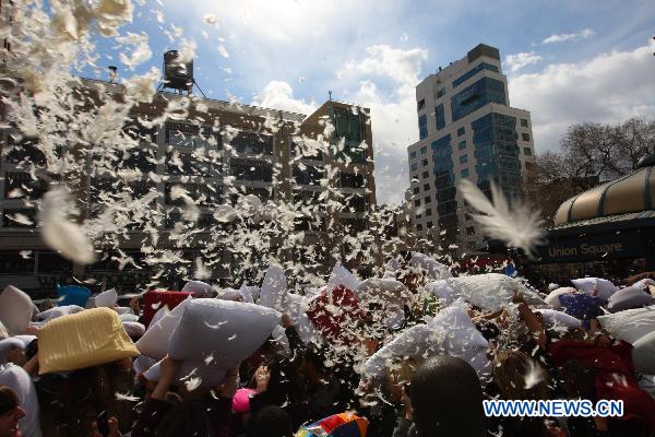 People participate in a pillow fight at the Union Square in New York, the United States, April 2, 2011. Crowds of revelers equipped with soft pillows enjoyed Saturday a massive pillow fight during the International Pillow Fighting Day here in New York. 
