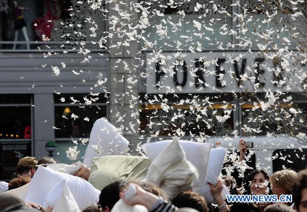 People participate in a pillow fight at the Union Square in New York, the United States, April 2, 2011. Crowds of revelers equipped with soft pillows enjoyed Saturday a massive pillow fight during the International Pillow Fighting Day here in New York. 