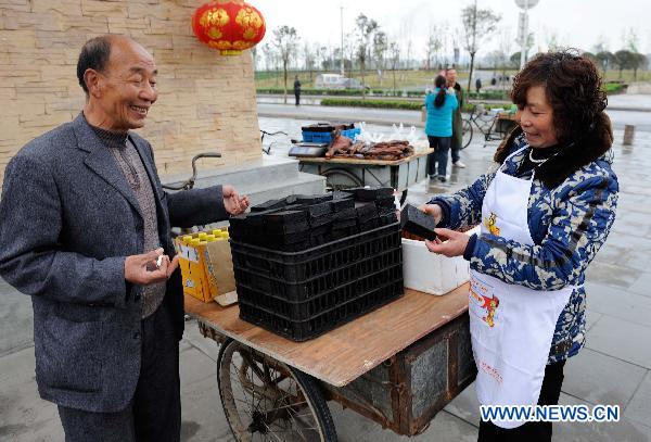 A snack vendor sells homemade 'dried bean curd' on a street in the new county seat of quake-jolted Beichuan, southwest China's Sichuan Province, April 5, 2011. 