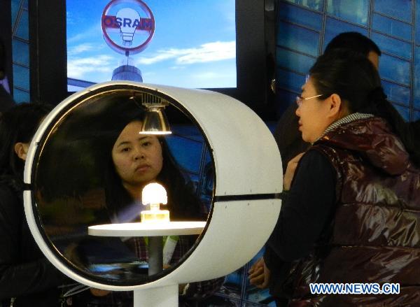Visitors look at a type of illuminative product at the 2011 illumination exhibition in Beijing, China, April 6, 2011. The three-day illumination exhibition opened here Wednesday, featuring low-carbon and energy saving products. 