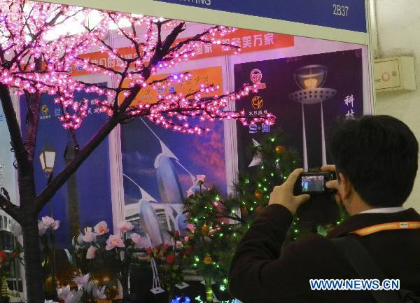 A visitor takes pictures of illuminative products at the 2011 illumination exhibition in Beijing, China, April 6, 2011. The three-day illumination exhibition opened here Wednesday, featuring low-carbon and energy saving products.f