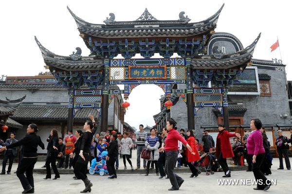 The photo taken on April 1, 2011 shows citizens dance in the rebuilt Shuimo Township in Wenchuan County, southwest China's Sichuan Province. Shuimo now takes on a picturesque new look due to the post-disaster reconstruction.