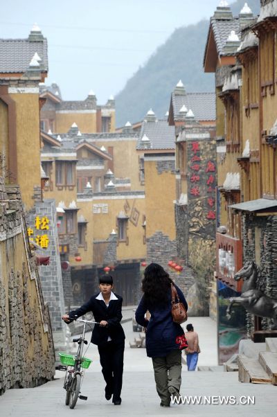 The photo taken on April 1, 2011 shows visitors walk leisurely in the rebuilt Shuimo Township in Wenchuan County, southwest China's Sichuan Province. Within less than three years after the deadly Wenchuan earthquake, many new towns have been rebuilt in quake-devastated areas. Shuimo now takes on a picturesque new look due to the post-disaster reconstruction. 