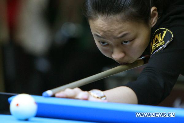 Chen Siming of China plays a shot against Reggie Ann Biagcong of the Philippines during the 2011 Philippine Open Pool Championships in Mandaluyong City, the Philippines, April 7, 2011. Chen won the game 9-1.(Xinhua/Rouelle Umali) 