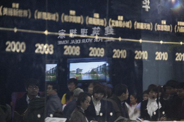 Crowds of people are reflected in a mirror at the 2011 Dalian Spring Realestate Trade Fair in Dalian, northeast China's Liaoning Province, April 8, 2011. (Xinhua/Chen Hao) 