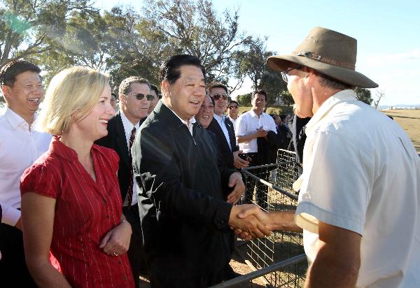 Jia Qinglin, chairman of the National Committee of the Chinese People's Political Consultative Conference, shakes hands with Ian Cusack during his visit to a ranch run by Cusack in Canberra, Australia, April 8, 2011. (Xinhua/Liu Weibing)