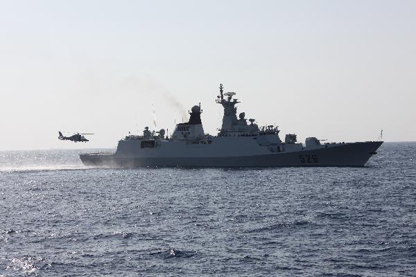 A helicopter carries out dispelling during an anti-piracy drill of the Chinese People&apos;s Liberation Army (PLA) Navy Eighth Escort Task Force in Gulf of Aden, on April 9, 2011. The Chinese People&apos;s Liberation Army (PLA) Navy Eighth Escort Task Force carried out the anti-piracy drill here on a Chinese merchant ship on Saturday. [Qiu Junsong/Xinhua]