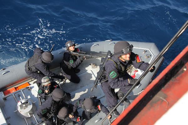 Chinese soldiers climb onto a &apos;target&apos; Chinese merchant ship during an anti-piracy drill of the Chinese People&apos;s Liberation Army (PLA) Navy Eighth Escort Task Force in Gulf of Aden, on April 9, 2011. The Chinese People&apos;s Liberation Army (PLA) Navy Eighth Escort Task Force carried out the anti-piracy drill here on a Chinese merchant ship on Saturday. [Qiu Junsong/Xinhua]