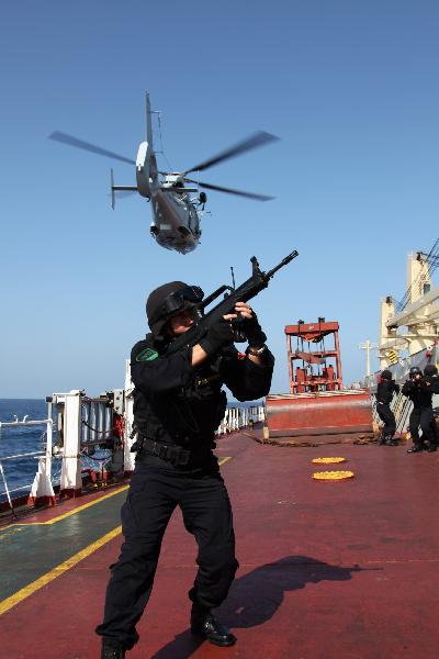 Chinese soldiers search for &apos;pirates&apos; on a &apos;target&apos; Chinese merchant ship during an anti-piracy drill of the Chinese People&apos;s Liberation Army (PLA) Navy Eighth Escort Task Force in Gulf of Aden, on April 9, 2011. The Chinese People&apos;s Liberation Army (PLA) Navy Eighth Escort Task Force carried out the anti-piracy drill here on a Chinese merchant ship on Saturday. [Qiu Junsong/Xinhua] 