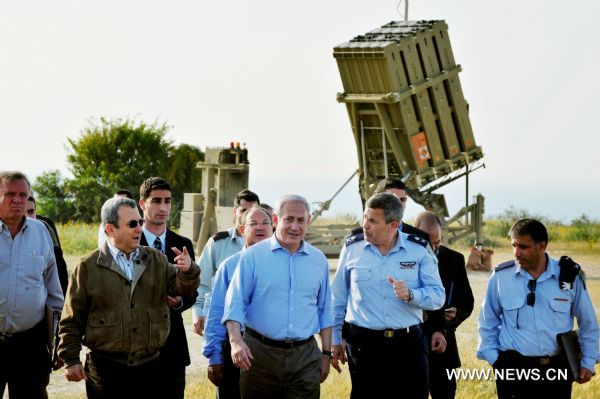 Israeli Prime Minister Benjamin Netanyahu (C) walks with troops during his tour of one of the Iron Dome batteries in Ashkelon, Israel, April 10, 2011. The anti-rocket defense system, the Iron Dome, in intercepting projectiles fired by Gaza militants at southern Israel over the weekend may hold strategic implications in regard to threats that Israel faces on other fronts, Israeli military sources say. (Xinhua/Rafael Ben-Ari) (wjd) 