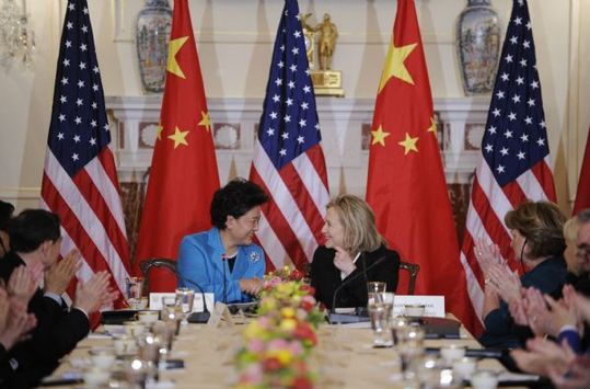 Chinese State Councilor Liu Yandong (L, central) talks with U. S. Secretary of State Hillary Clinton during the second round of high-level consultation meeting on people-to-people and cultural exchanges between the two countries, in Washington D.C., capital of the United States, April 12, 2011. [Zhang Jun/Xinhua]