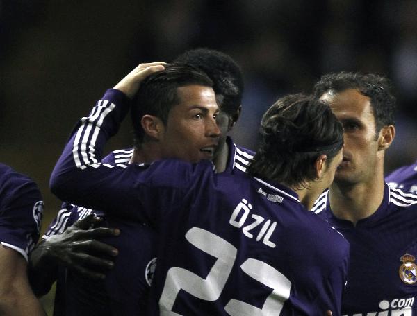 Real Madrid's Cristiano Ronaldo (L) is congratulated by teammates after scoring a goal against Tottenham Hotspur during the second leg of their Champions League quarter-final soccer match at White Hart Lane in London April 13, 2011. (Xinhua/Reuters Photo)