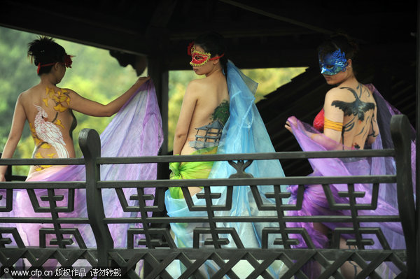 Models pose with paintings on their body at the Enlong scenic spot in Ningguo city, East China's Anhui province, April 13, 2011.