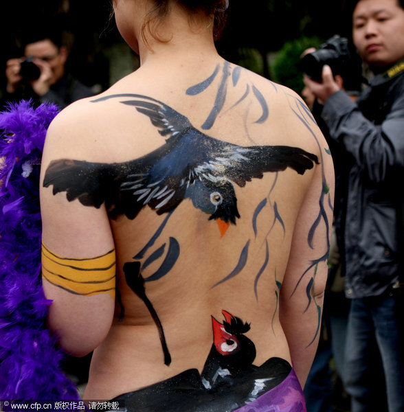  A model with a parrot painted on her body poses for photos at the Enlong scenic spot in Ningguo city, East China's Anhui province, April 13, 2011.