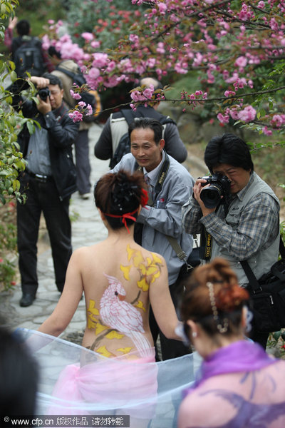 Models pose with paintings on their body at the Enlong scenic spot in Ningguo city, East China's Anhui province, April 13, 2011. 