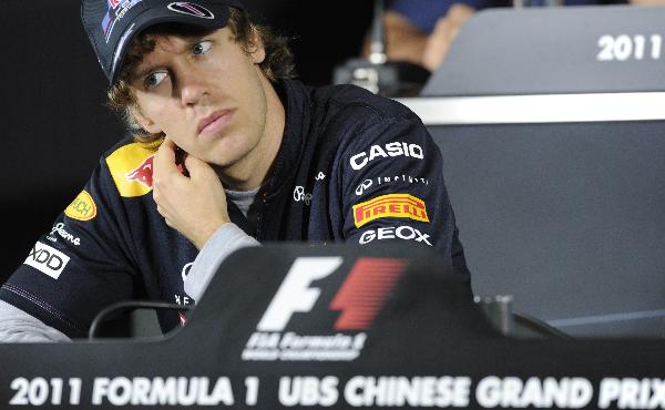 Red Bull Racing driver Sebastian Vettel of Germany listens to a question during a press conference at the Shanghai International Circuit on April 14, 2011, ahead of the 2011 Formula One's Chinese Grand Prix. McLaren and Ferrari may look to Mark Webber to help clip his teammate Sebastian Vettel's wings in this weekend's Chinese Grand Prix -- and end his runaway start to the 2011 world title race. (Xinhua/AFP Photo)