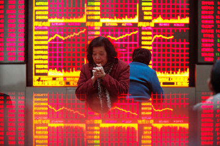 Investors monitor stock prices at a securities exchange company in Shanghai. Goldman Sachs Group Inc predicts the Shanghai-Shenzhen 300 Index will reach 3,500 points by the end of the second quarter and hit 4,000 points at the end of the year. [Bloomberg]