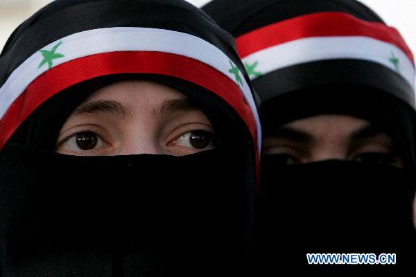 Two veiled Syrian female protesters are seen during a sit-in attended by scores of Syrians living in Jordan against Bashar's government and the ruling Baath Party in front of Syrian embassy in Amman, capital of Jordan, on April 17, 2011. [Mohammad Abu Ghosh/Xinhua]