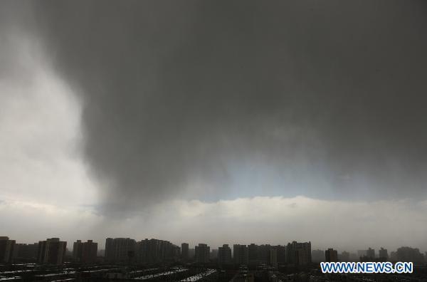 Dark cloud come down on the city of Beijing, capital of China, April 17, 2011. Beijing witnessed a windy day with rainfall in some areas. [Xinhua] 