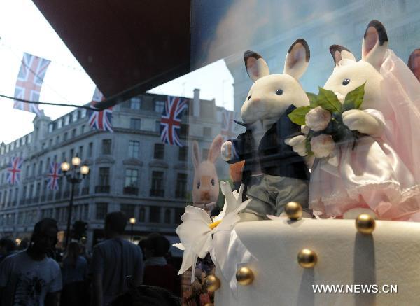 British flags are reflected on a window of a store on Regent Street in central London, April 19, 2011. A bunting of British flags goes up on Regent Street to celebrate the upcoming wedding of Prince William and his fiancée Kate Middleton, which will be held at Westminster Abbey in London on April 29. [Xinhua]