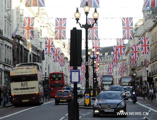 British flags are seen over Regent Street in central London, April 19, 2011. A bunting of British flags goes up on Regent Street to celebrate the upcoming wedding of Prince William and his fiancée Kate Middleton, which will be held at Westminster Abbey in London on April 29. [Xinhua]