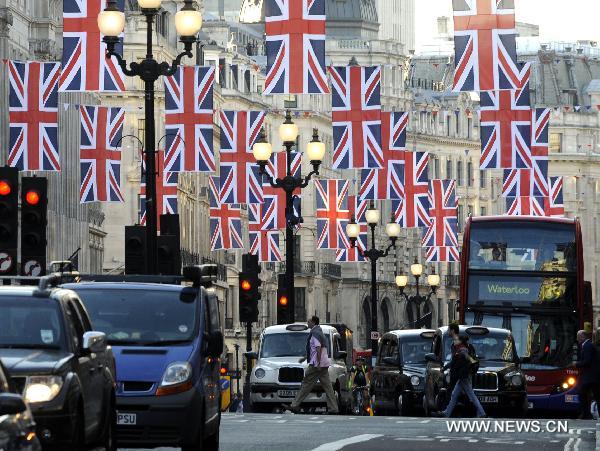 British flags are seen over Regent Street in central London, April 19, 2011. A bunting of British flags goes up on Regent Street to celebrate the upcoming wedding of Prince William and his fiancée Kate Middleton, which will be held at Westminster Abbey in London on April 29. [Xinhua]