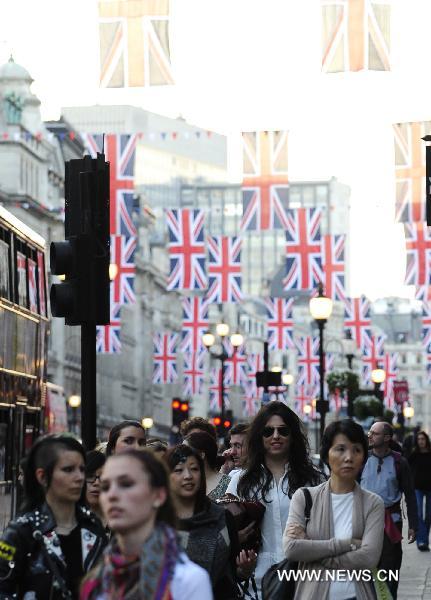 British flags are seen over Regent Street in central London, April 19, 2011. A bunting of British flags goes up on Regent Street to celebrate the upcoming wedding of Prince William and his fiancée Kate Middleton, which will be held at Westminster Abbey in London on April 29. [Xinhua]