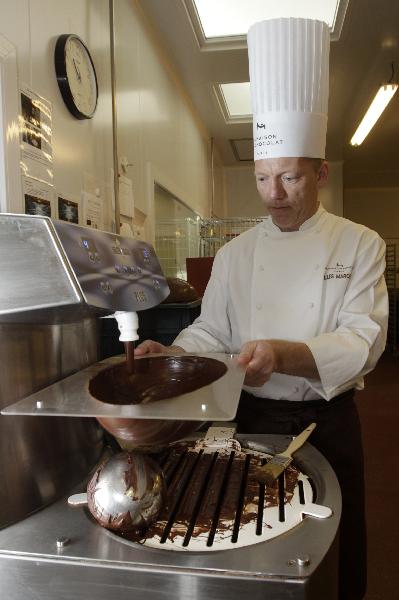 La Maison du Chocolat's creative director Gilles Marchal fills the inside of an egg-shaped mould with chocolate in preparations for Easter at their workshop in Nanterre, near Paris April 20, 2011. Some 13,000 tonnes of chocolate are sold in France during the Easter holiday period, which counts for 3.5 percent of total yearly sales or even more for luxury chocolate stores. [Xinhua/Reuters]