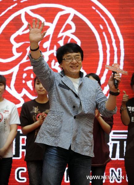 Movie star Jackie Chan (front) is seen at the opening ceremony of the cinema named after him in Shenyang, capital of northeast China's Liaoning Province, April 20, 2011. [Wang Jiang/Xinhua]