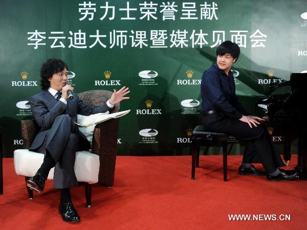 Chinese pianist Li Yundi (L) gives instructions during his class at China's National Center for Performing Arts in Beijing, capital of China, April 20, 2011. Li Yundi was best known for being the first, yet the youngest Chinese pianist winning the International Frederic Chopin Piano Competition in 2000, while he was at the age of 18. [Luo Xiaoguang/Xinhua]