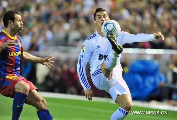 Real Madrid's Cristiano Ronaldo (R) controls the ball during the King's Cup final soccer match against Barcelona at Mestalla stadium in Valencia, Spain, April 20, 2011. Real Madrid claimed the champion by defeating Barcelona 1-0. [Chen Haitong/Xinhua]