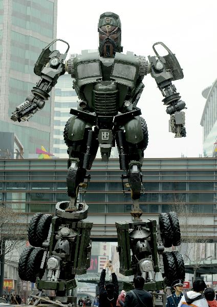 A transformer model featuring legendary Chinese general Guan Yu towers up on a street in downtown Shenyang, northeast China's Liaoning Province, April 20, 2011.