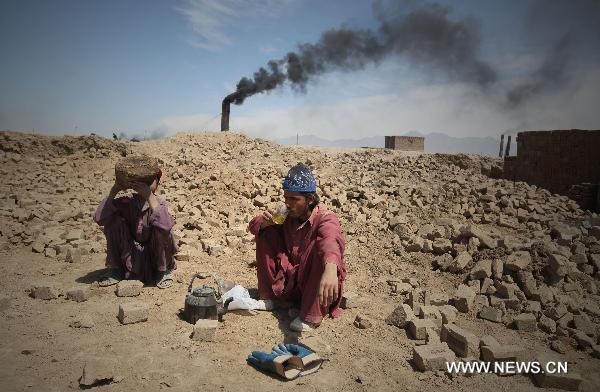 Afghan workers take break at a brick factory in outskirt of Kabul, Afghanistan, on April 17, 2011. Air pollution in Afghan big cities, particularly the capital city Kabul, has reached alarming point as head of National Environment Directorate, Mustafa warned last Sunday of dire consequences if air pollution is not checked. [Ahmad Massoud/Xinhua]