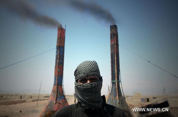 An Afghan worker poses for a photo at a brick factory in outskirt of Kabul, Afghanistan, on April 17, 2011. Air pollution in Afghan big cities, particularly the capital city Kabul, has reached alarming point as head of National Environment Directorate, Mustafa warned last Sunday of dire consequences if air pollution is not checked. [Ahmad Massoud/Xinhua]