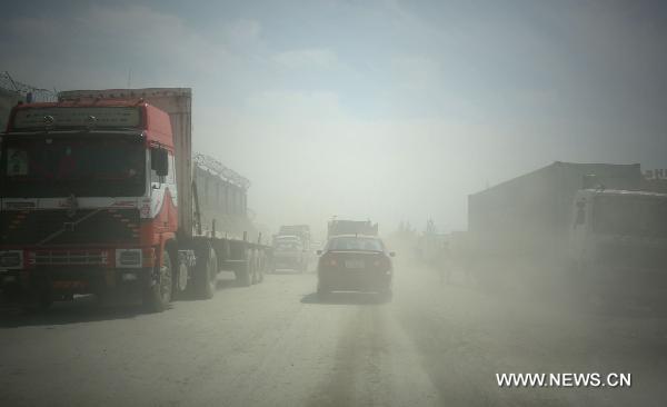Vehicles are seen in the dusty street in outskirt of Kabul, Afghanistan, on April 17, 2011. Air pollution in Afghan big cities, particularly the capital city Kabul, has reached alarming point as head of National Environment Directorate, Mustafa warned last Sunday of dire consequences if air pollution is not checked. [Ahmad Massoud/Xinhua]