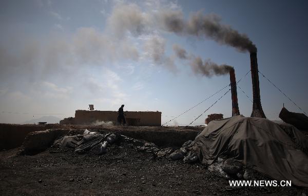 An Afghan worker works at a brick factory in outskirt of Kabul, Afghanistan, on April 17, 2011. Air pollution in Afghan big cities, particularly the capital city Kabul, has reached alarming point as head of National Environment Directorate, Mustafa warned last Sunday of dire consequences if air pollution is not checked. [Ahmad Massoud/Xinhua]