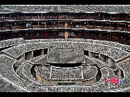 Photo shows the Tianluokeng Tulou, earth buildings in Chinese, in Nanjing County, southeast China's Fujian Province. Built on a base of stone, the thick walls of Tulou were packed with dirt and fortified with wood or bamboo internally. The architectural arts of the Fujian Tulou can be traced back nearly 1,000 years, and their design incorporates the tradition of fengshui (favorable siting within the environment). [China.org.cn] 