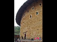 Photo shows the Tianluokeng Tulou, earth buildings in Chinese, in Nanjing County, southeast China's Fujian Province. Built on a base of stone, the thick walls of Tulou were packed with dirt and fortified with wood or bamboo internally. The architectural arts of the Fujian Tulou can be traced back nearly 1,000 years, and their design incorporates the tradition of fengshui (favorable siting within the environment). [China.org.cn] 
