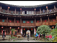 Photo shows the Tianluokeng Tulou, earth buildings in Chinese, in Nanjing County, southeast China's Fujian Province. Built on a base of stone, the thick walls of Tulou were packed with dirt and fortified with wood or bamboo internally. The architectural arts of the Fujian Tulou can be traced back nearly 1,000 years, and their design incorporates the tradition of fengshui (favorable siting within the environment). [China.org.cn] 
