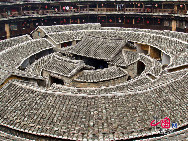 Photo shows the Tianluokeng Tulou, earth buildings in Chinese, in Nanjing County, southeast China's Fujian Province. Built on a base of stone, the thick walls of Tulou were packed with dirt and fortified with wood or bamboo internally. The architectural arts of the Fujian Tulou can be traced back nearly 1,000 years, and their design incorporates the tradition of fengshui (favorable siting within the environment). [China.org.cn] 