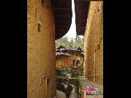 Photo shows the Tianluokeng Tulou, earth buildings in Chinese, in Nanjing County, southeast China's Fujian Province. Built on a base of stone, the thick walls of Tulou were packed with dirt and fortified with wood or bamboo internally. The architectural arts of the Fujian Tulou can be traced back nearly 1,000 years, and their design incorporates the tradition of fengshui (favorable siting within the environment). [China.org.cn] 