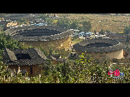 Photo shows the Tianluokeng Tulou, earth buildings in Chinese, in Nanjing County, southeast China's Fujian Province. Built on a base of stone, the thick walls of Tulou were packed with dirt and fortified with wood or bamboo internally. The architectural arts of the Fujian Tulou can be traced back nearly 1,000 years, and their design incorporates the tradition of fengshui (favorable siting within the environment). [China.org.cn] 