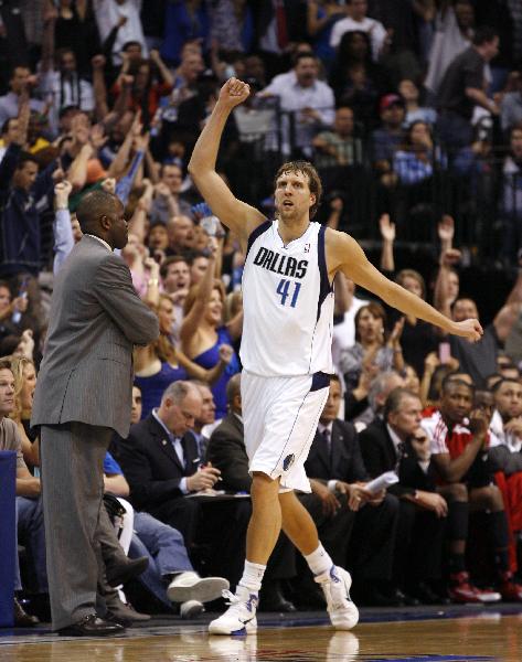 Dallas Mavericks forward Dirk Nowitzki (R) celebrates after hitting a shot as Portland Trail Blazers head coach Nate McMillan looks on, during the second half of Game 2 of their NBA Western Conference playoff series in Dallas, Texas April 19, 2011. (Xinhua/Reuters Photo) 