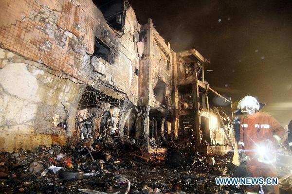 Rescuers work at an explosion site in Xinbei City, southeast China&apos;s Taiwan, April 23, 2011. An explosion at a paper mill occurred Friday evening in Xinbei City of Taiwan, leaving at least 4 people dead and another 33 injured. [Xinhua]